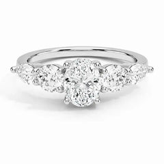 Oval moissanite engagement ring with round side stones in a silver band, brilliant cut.