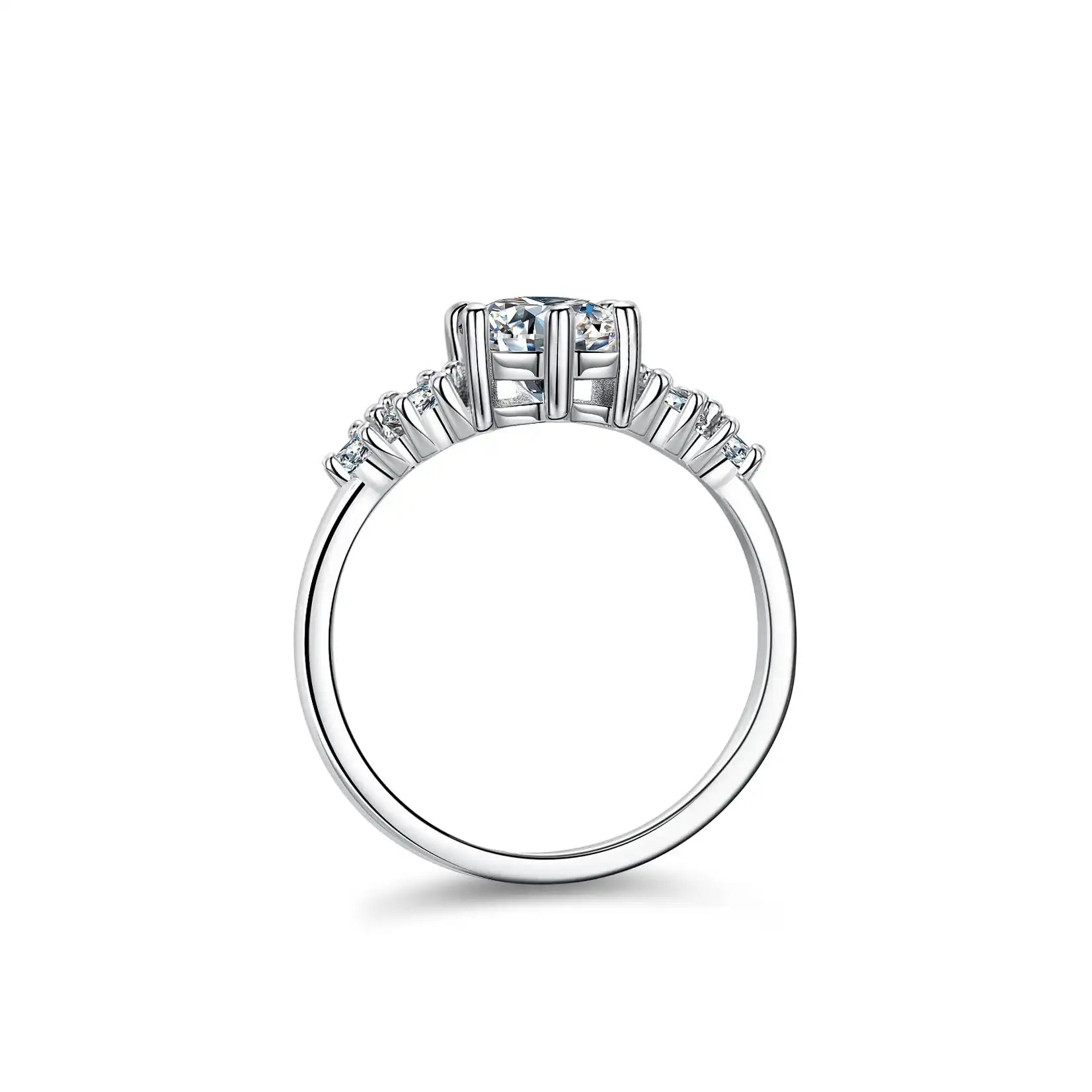 Side view of a moissanite engagement ring with a central stone and smaller accent stones on a silver band