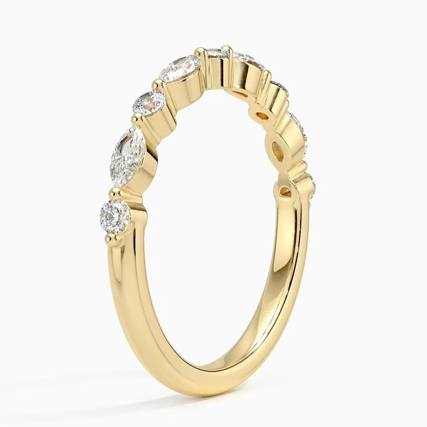 Gold moissanite ring with oval and round stones in prong settings, elegant fine jewelry