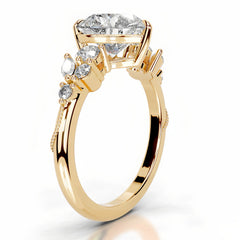 Gold moissanite engagement ring with side stones and intricate prong setting
