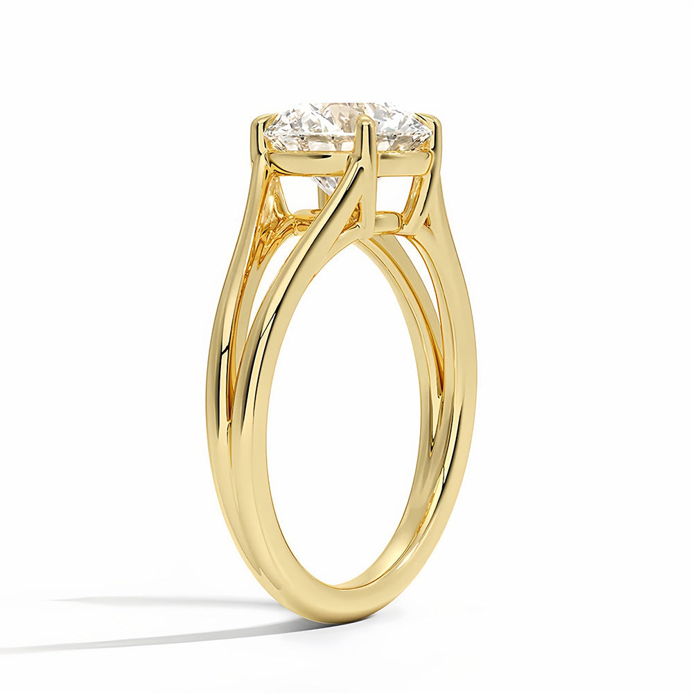 Gold solitaire ring with round brilliant moissanite gemstone on white background
