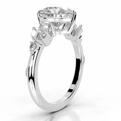 White gold ring with a large moissanite center stone and side accent stones on a polished band