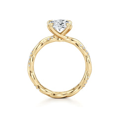 Gold solitaire ring with a round moissanite center stone and pavé accents on band