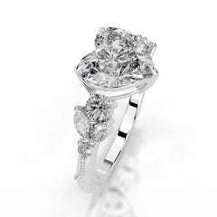 Heart-shaped moissanite engagement ring with diamond-like side stones on silver band