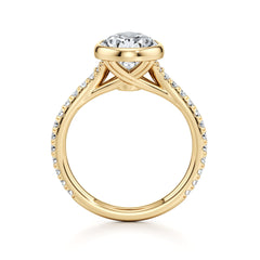 Gold moissanite engagement ring with round center stone and pavé band, side view