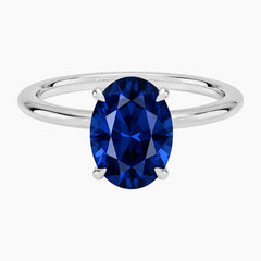 Top-down view of a classic 2-carat oval-cut lab-grown sapphire ring set in a polished 18K white gold-plated band.