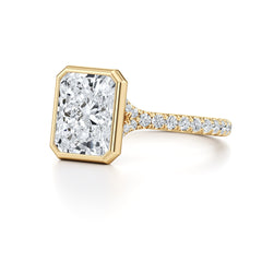 Radiant cut moissanite ring with gold band and pavé setting, premium jewelry close-up
