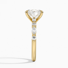 Yellow gold ring with round and marquise moissanite stones in prong setting, side view