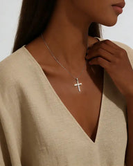 Woman wearing moissanite cross pendant necklace, elegant jewelry for special occasions