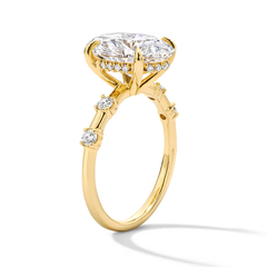 Gold moissanite engagement ring with round brilliant center stone and side accents