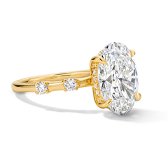 Oval moissanite solitaire ring in yellow gold with side accent stones