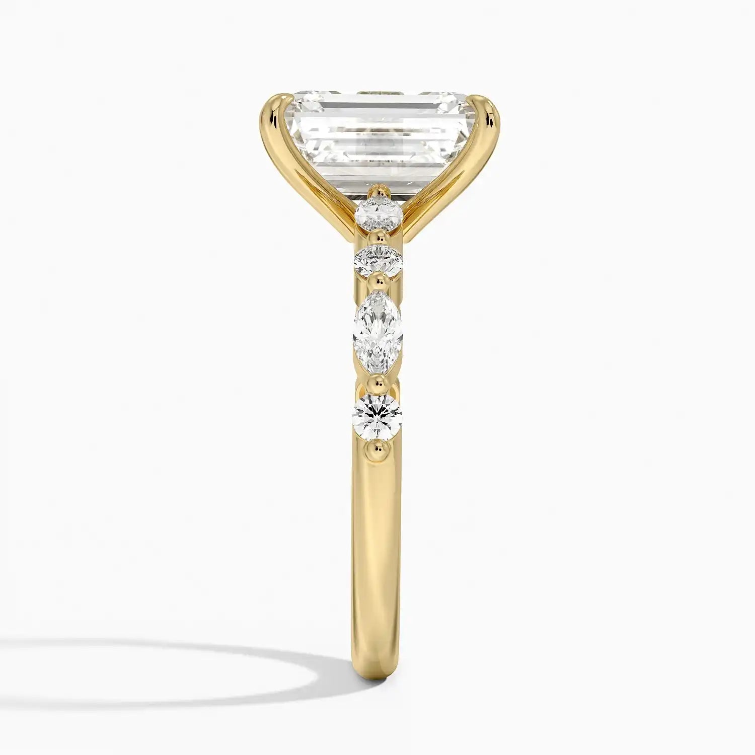 Side view of a gold ring with a large emerald-cut moissanite and accent stones