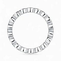 Silver moissanite eternity ring with geometric design on white background