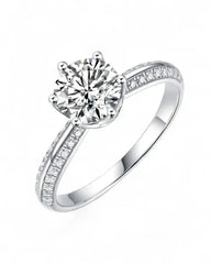 Solitaire moissanite engagement ring with pavé band in white metal