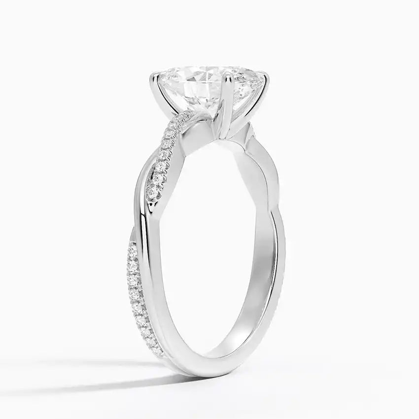 Moissanite engagement ring with pave band in white gold on white background