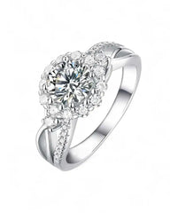 Silver moissanite halo engagement ring with round center stone and pavé band