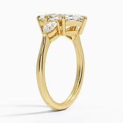 Gold moissanite engagement ring with three stones, side view showcasing elegant setting