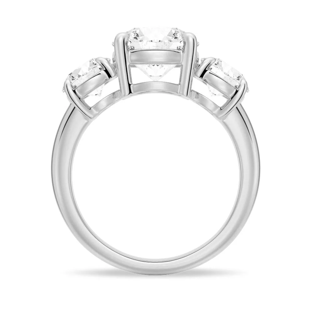 Three-stone moissanite ring with round brilliant gems in a white metal setting