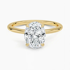 Oval cut moissanite solitaire engagement ring with yellow gold band