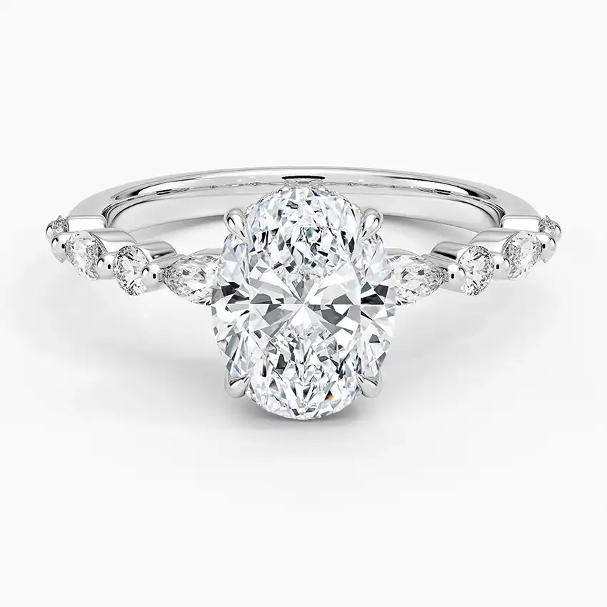 Oval moissanite engagement ring with diamond accents on a polished silver band