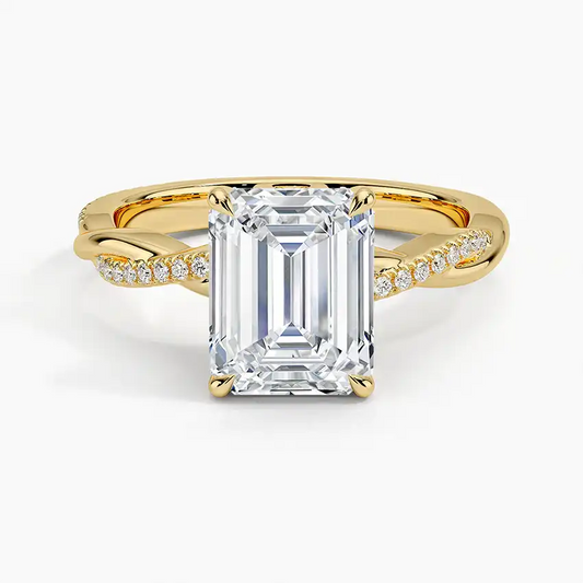 Emerald cut moissanite engagement ring with twisted gold band and pavé side stones
