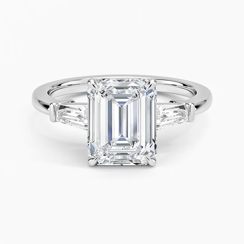Emerald cut moissanite engagement ring with tapered baguette side stones in white gold