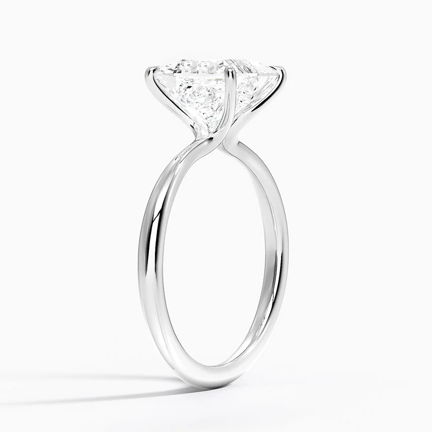 Solitaire moissanite engagement ring with a round brilliant stone in a prong setting