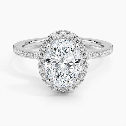 Oval moissanite halo engagement ring with pavé band in white metal, sparkling center stone