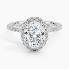 Oval moissanite halo engagement ring with pavé band in white metal, sparkling center stone