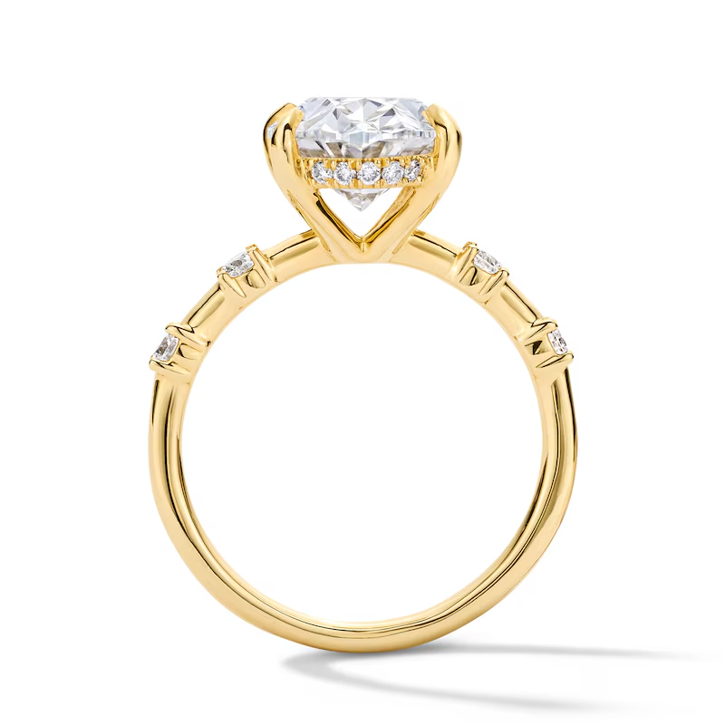 Gold moissanite engagement ring with round brilliant center stone and pavé side details