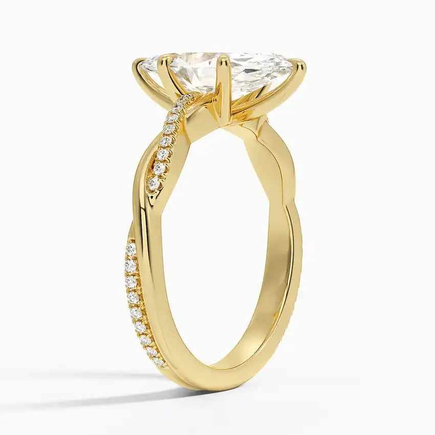 Gold moissanite engagement ring with pavé band and large center stone on white background