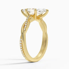 Gold moissanite engagement ring with pavé band and large center stone on white background