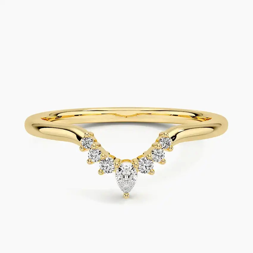 Gold moissanite chevron ring with pear and round stones on a white background