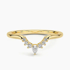 Gold moissanite chevron ring with pear and round stones on a white background