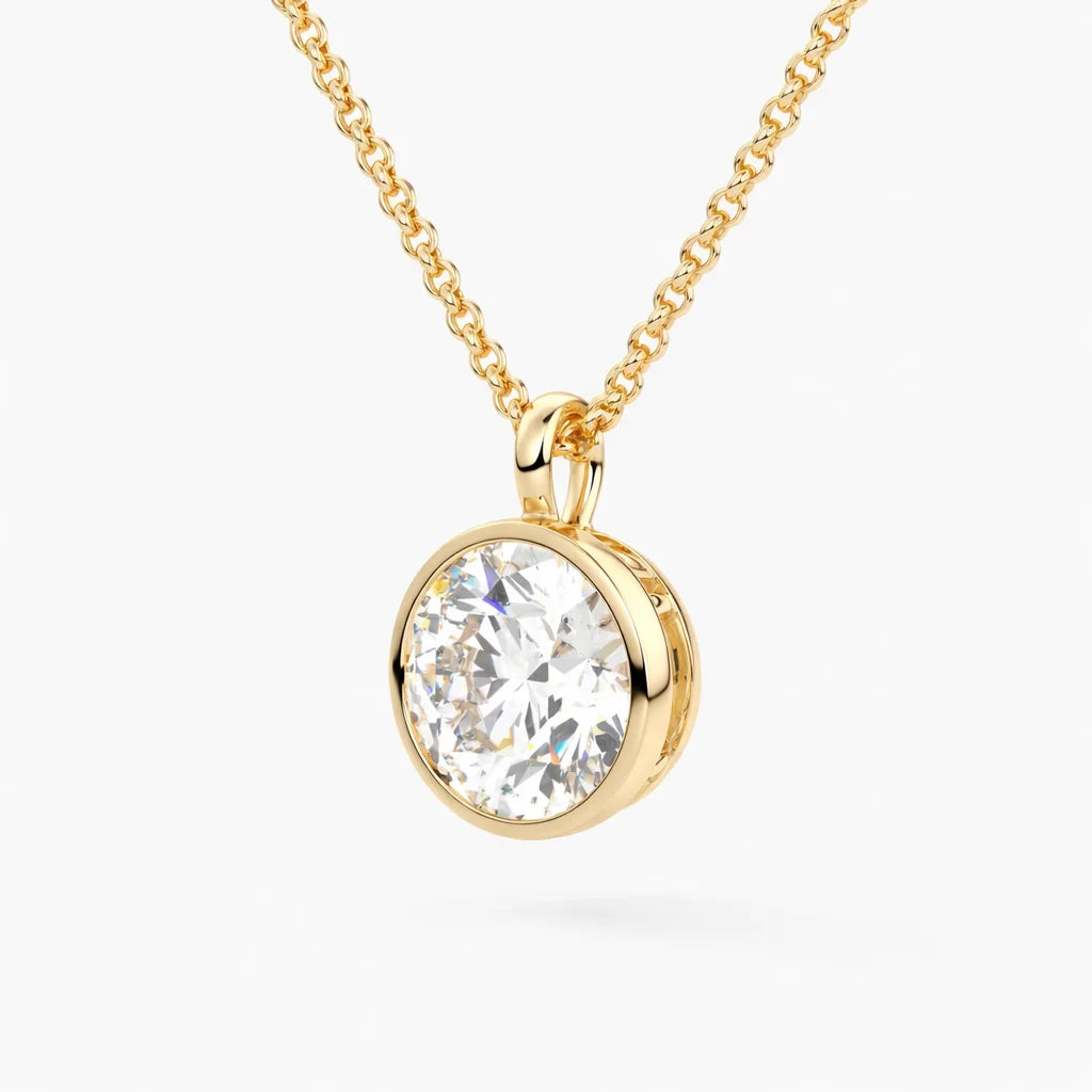 Gold chain necklace with round moissanite pendant in bezel setting on white background.