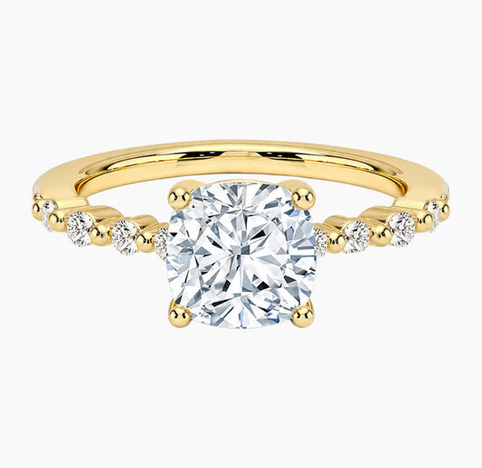 Cushion-cut moissanite ring featuring an 18K white gold-plated band set with pavé diamonds; an elegant solitaire-style engagement ring.