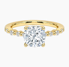 Cushion-cut moissanite ring featuring an 18K white gold-plated band set with pavé diamonds; an elegant solitaire-style engagement ring.