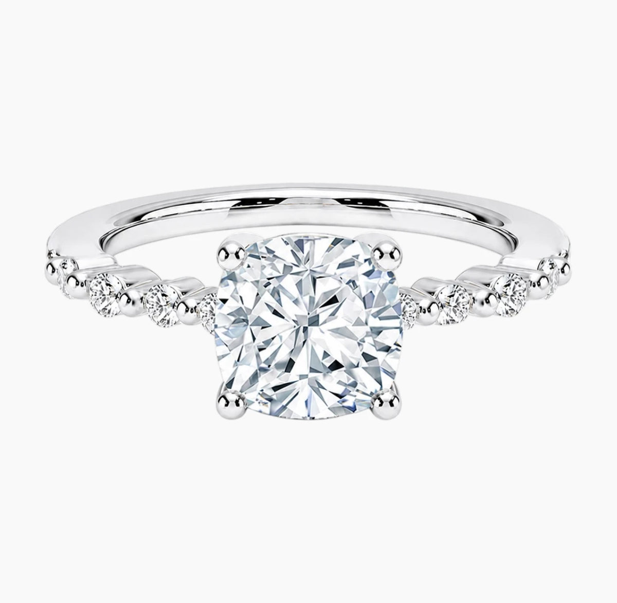 Cushion-cut moissanite ring featuring an 18K white gold-plated band set with pavé diamonds; an elegant solitaire-style engagement ring.