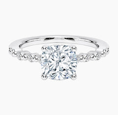 Cushion-cut moissanite ring featuring an 18K white gold-plated band set with pavé diamonds; an elegant solitaire-style engagement ring.