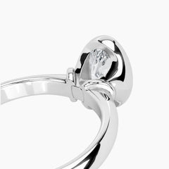 Angled view of a round bezel set moissanite engagement ring with a smooth 2.6mm band