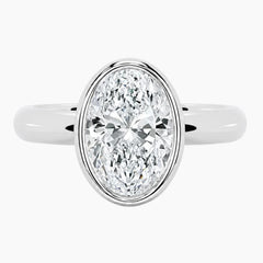 Oval bezel moissanite ring featuring a brilliant oval-cut stone and polished 2.6mm yellow gold comfort-fit band.