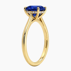Side profile view of a Stdiam 18K gold-plated ring showcasing a 2-carat oval lab-grown sapphire and a subtle hidden halo setting