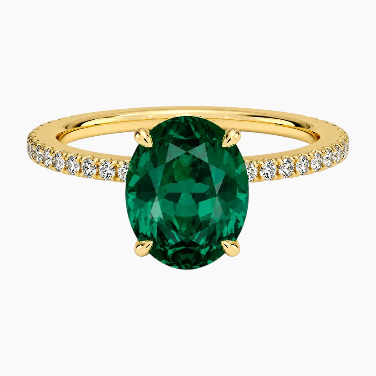 Oval cut deep green lab-grown emerald ring with a delicate pave band