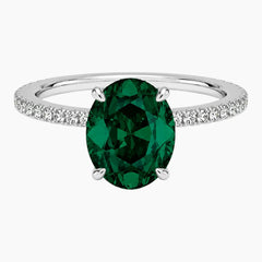 Oval cut deep green lab-grown emerald ring with a delicate pave band