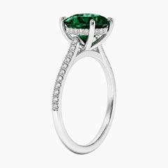 Oval cut deep green lab-grown emerald ring with a delicate pave band