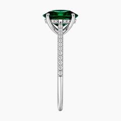 Oval cut deep green lab-grown emerald ring with a delicate pave band