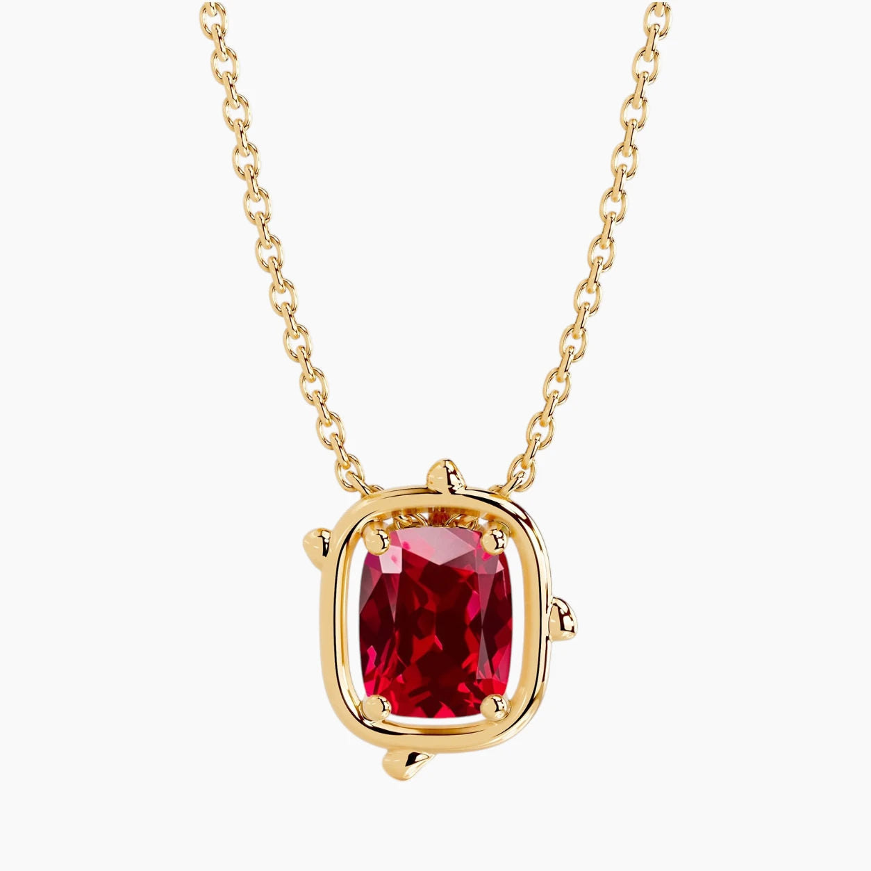 6×8mm cushion-cut ruby pendant necklace in 14K yellow gold with a minimalist bezel-inspired setting and delicate cable chain on a white background.