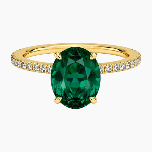 Oval cut deep green lab-grown emerald ring with a delicate pave band