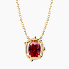 6×8mm cushion-cut ruby pendant necklace in 14K yellow gold with a minimalist bezel-inspired setting and delicate cable chain on a white background.