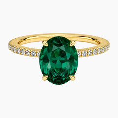 Oval cut deep green lab-grown emerald ring with a delicate pave band